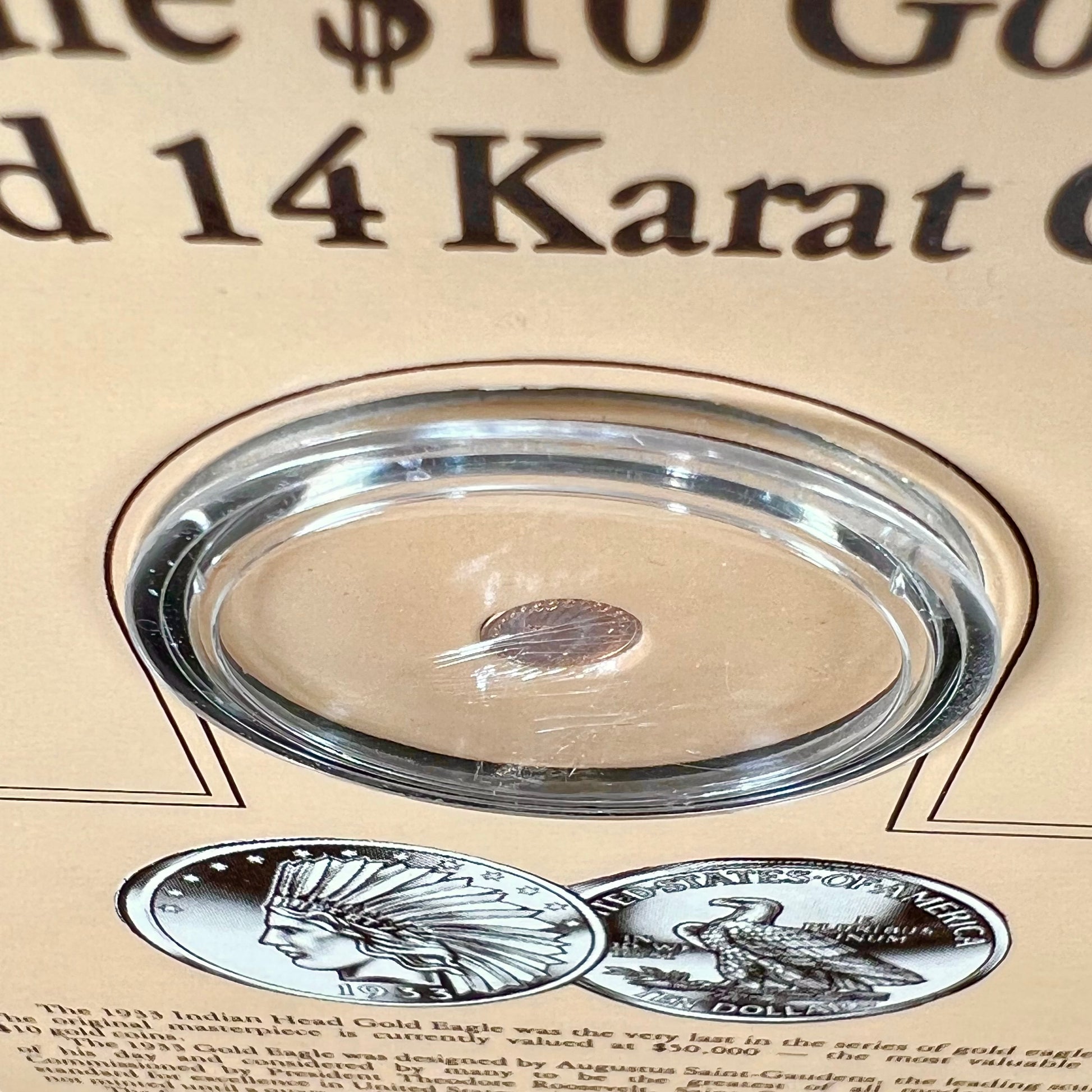 A 14 karat gold miniature commemorative of a 1933 Indian Head Gold Eagle coin.