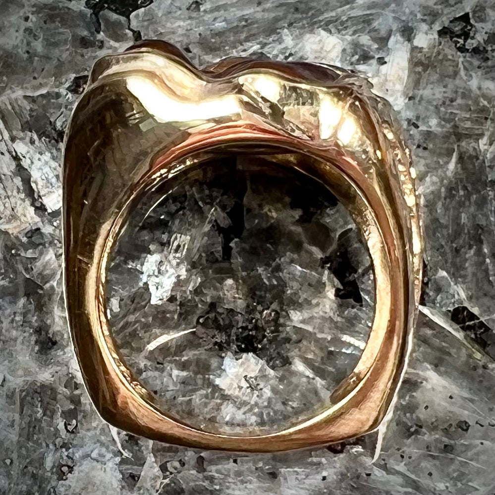 A men's custom fire agate solitaire ring cast in yellow gold.