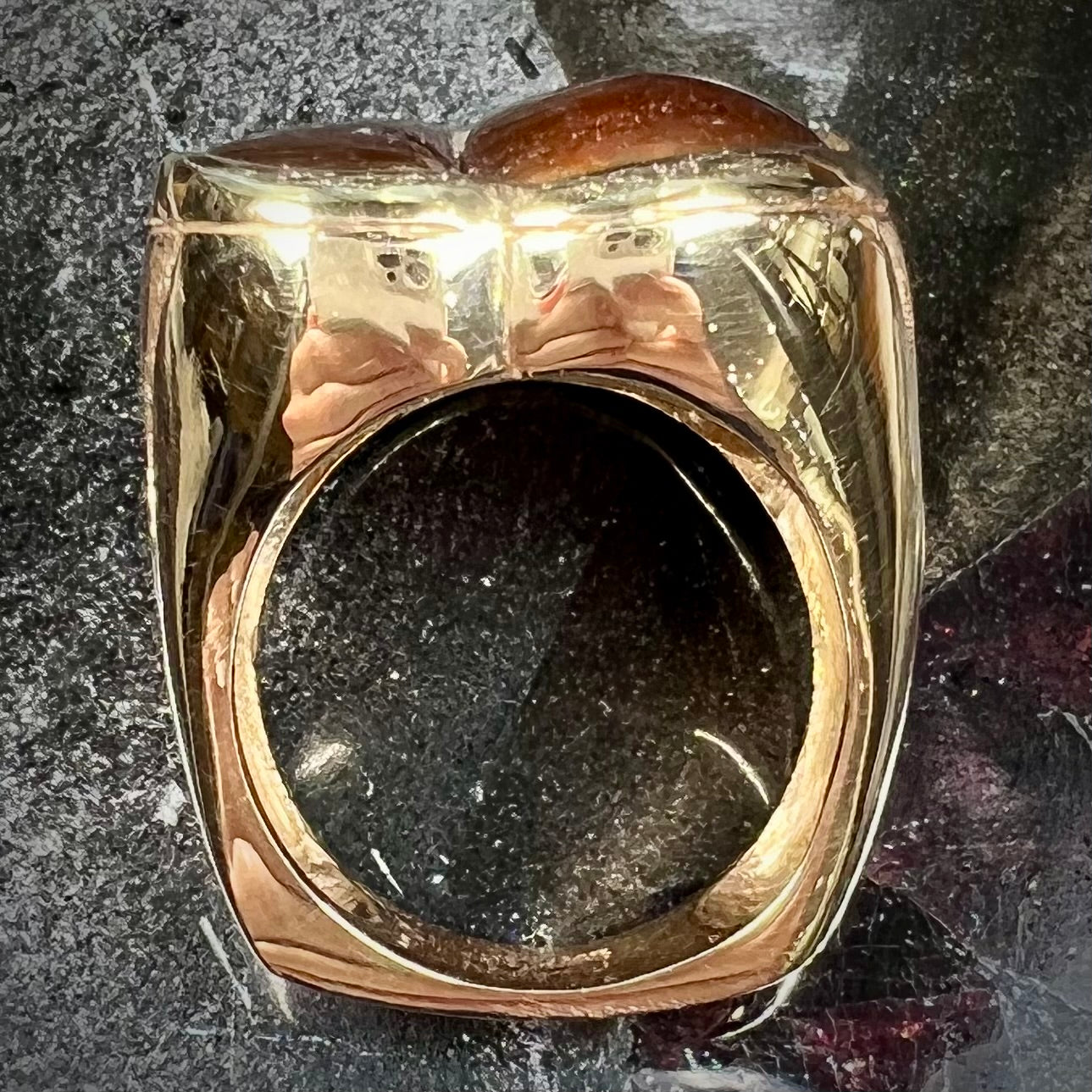 A men's yellow gold ring inlaid with three freeform cut fire agate stones.