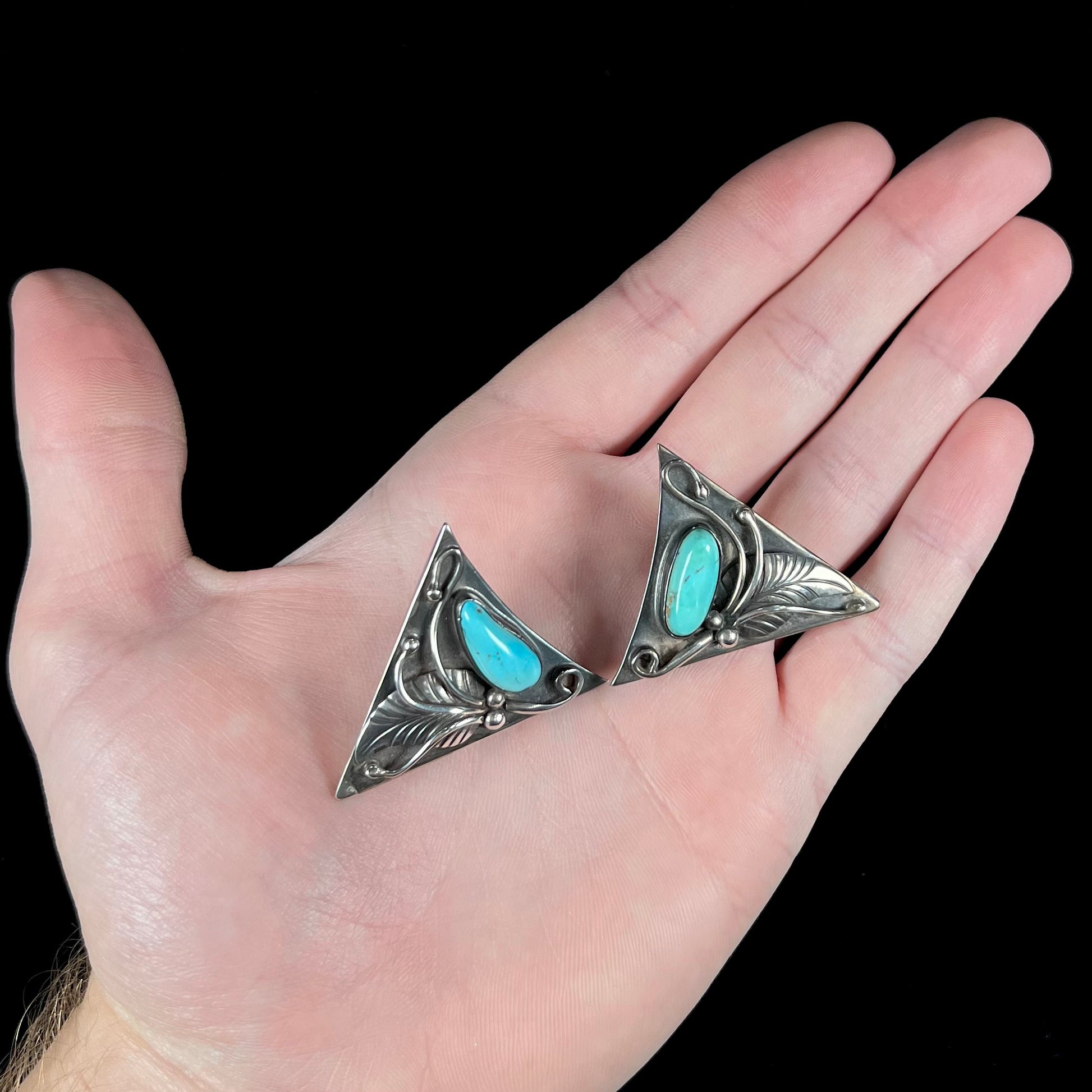 A pair of sterling silver and turquoise shirt collar tips handmade by Navajo artist, Phillip Guerro.