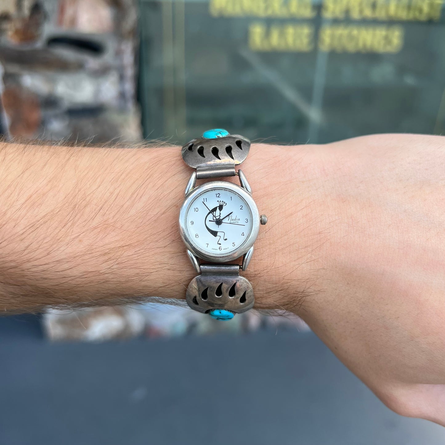 A watch set with two turquoise stones handmade by Navajo artists Arnold and Carleena Goodluck.