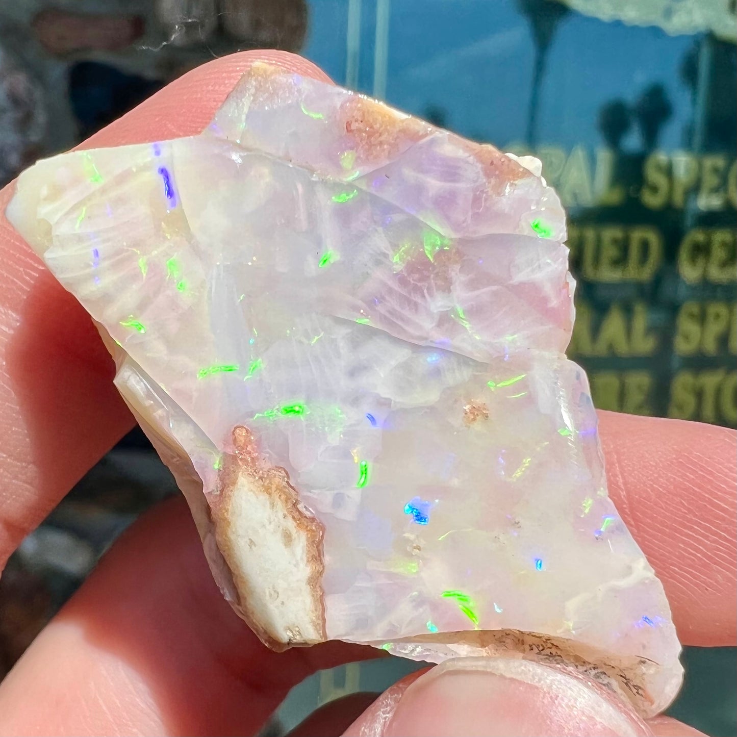 A loose, polished specimen of white crystal opal from Spencer, Idaho, USA.