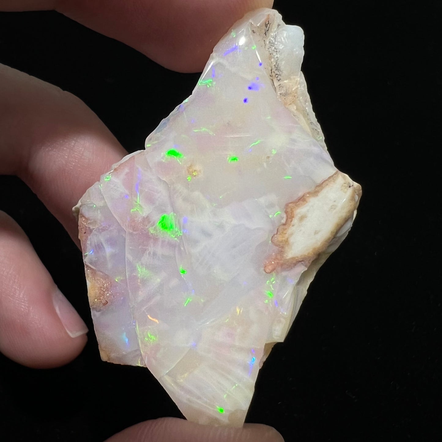 A loose, polished specimen of white crystal opal from Spencer, Idaho, USA.