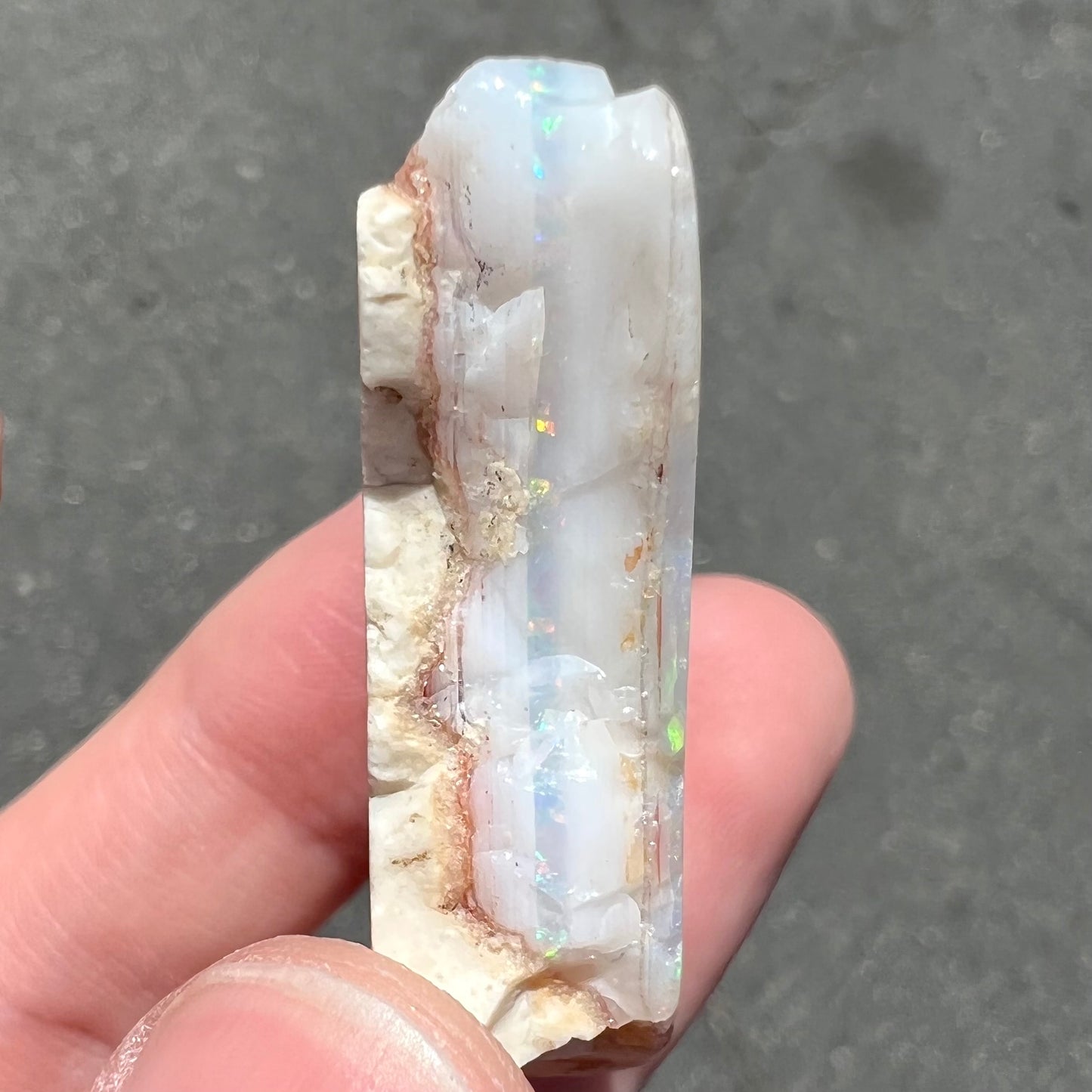 A loose, polished specimen of white crystal opal from Spencer, Idaho, USA.