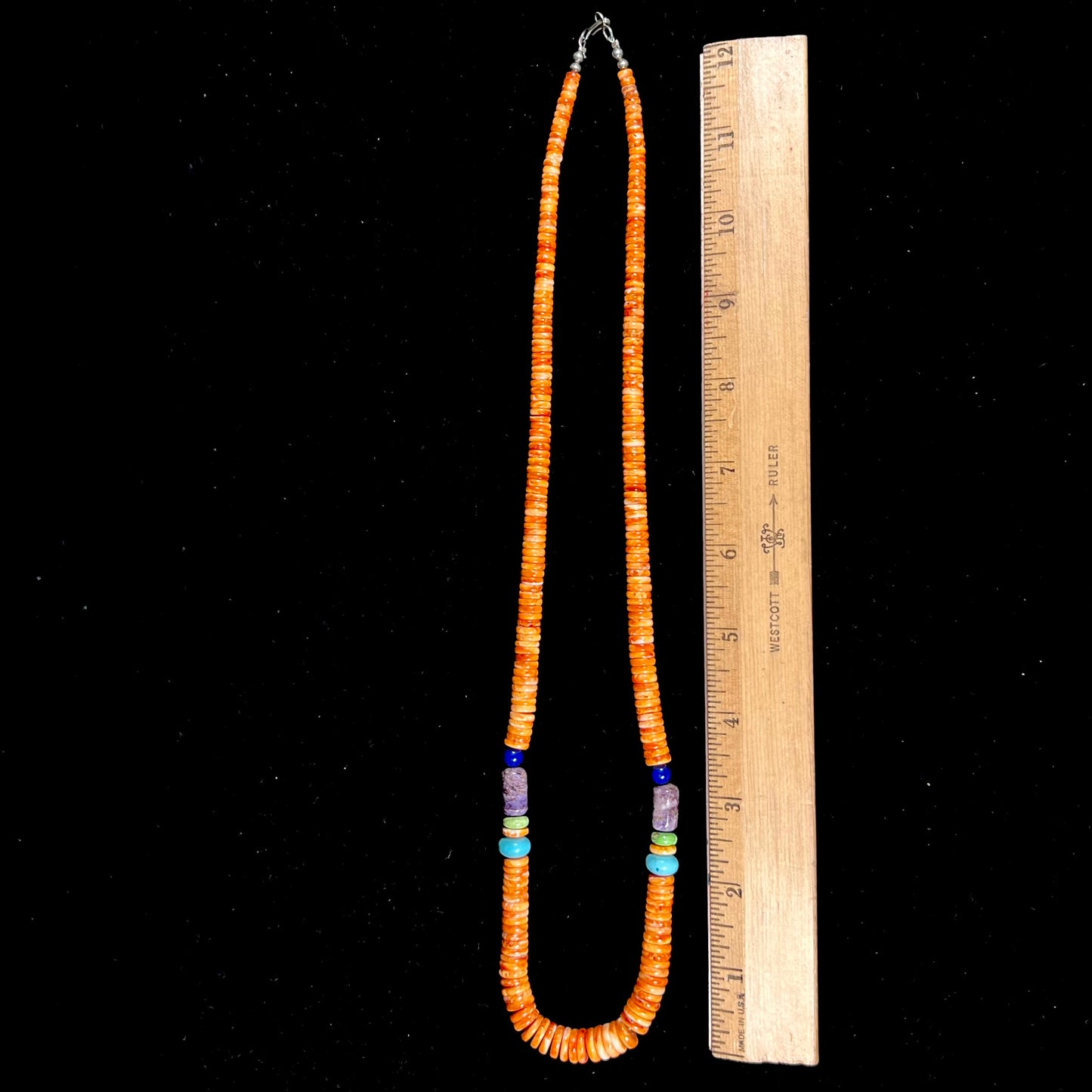 A heishi Santo Domingo bead necklace made from polished spiny oyster, turquoise, gaspeite, charoite, and lapis lazuli.