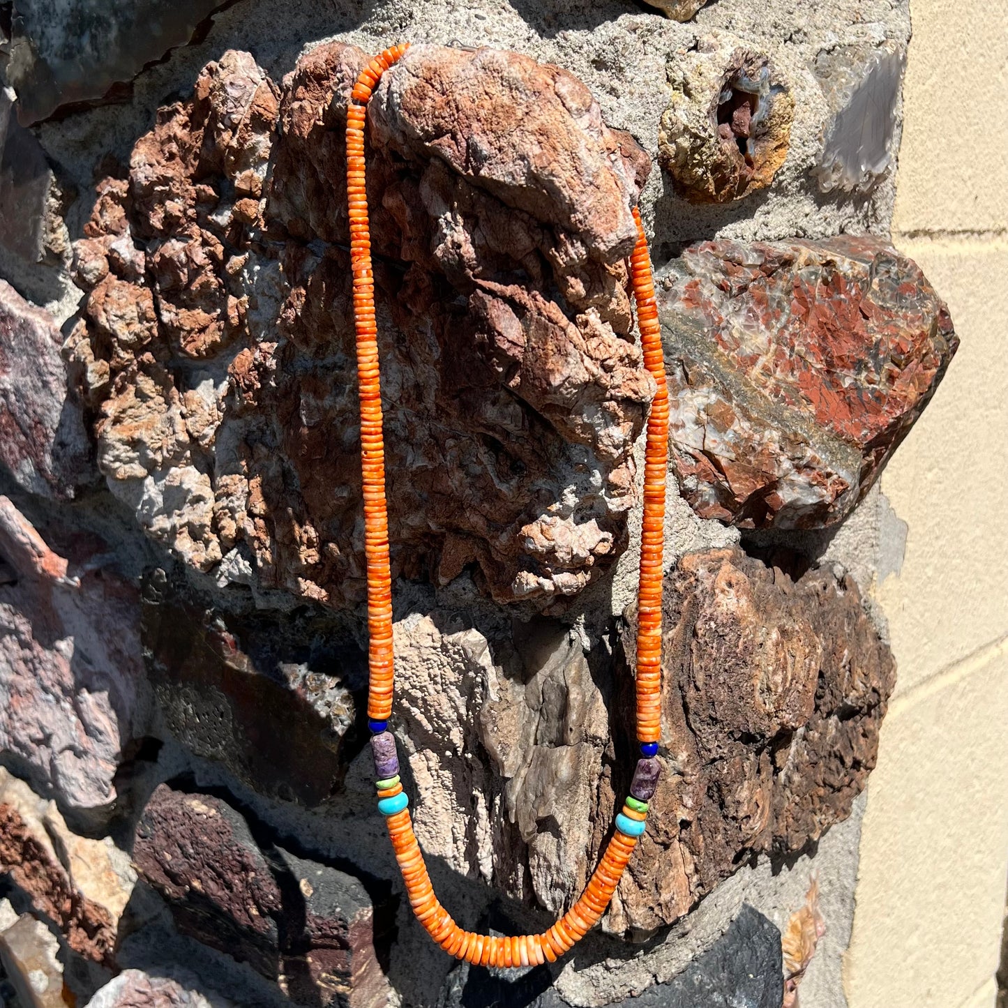 A heishi Santo Domingo bead necklace made from polished spiny oyster, turquoise, gaspeite, charoite, and lapis lazuli.