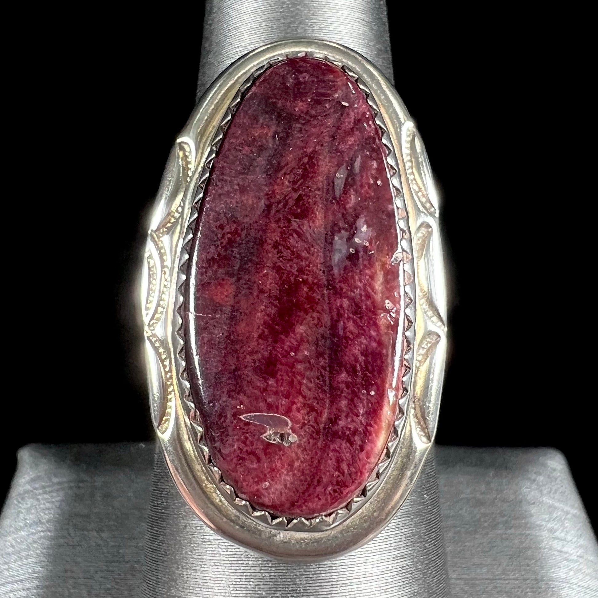 A sterling silver ring set with a purple spiny oyster shell, handmade by the Hopi Indian artist.
