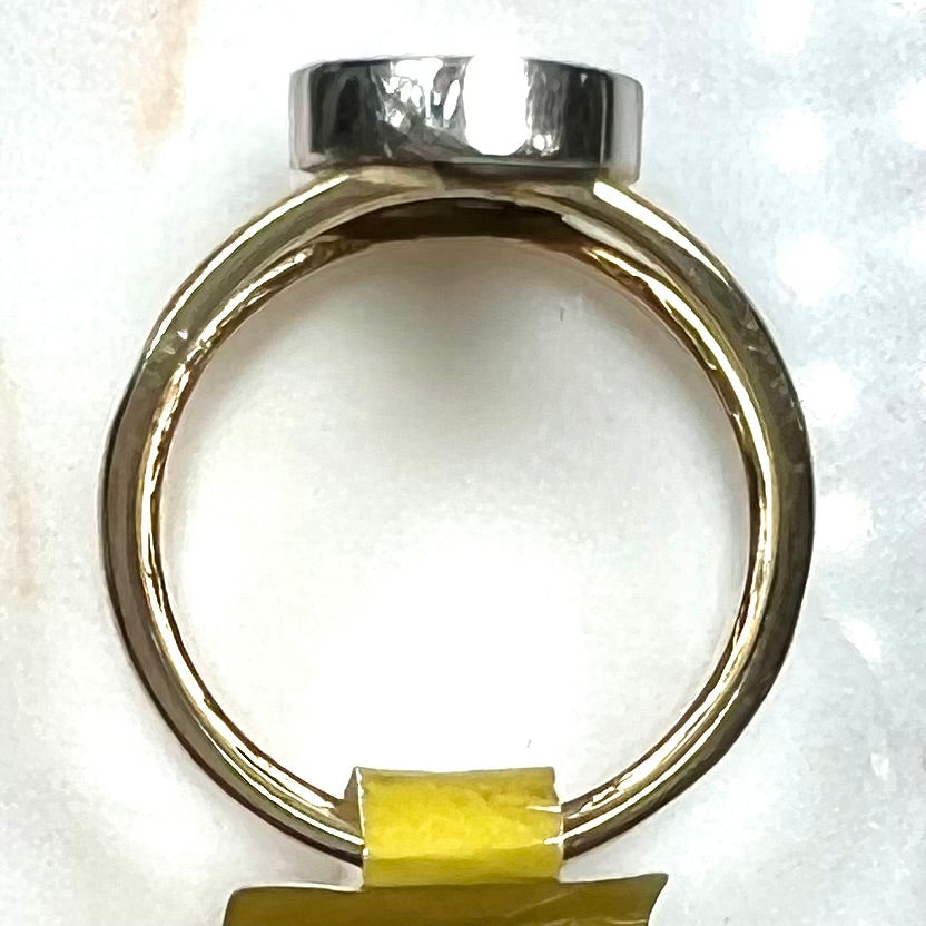 A two tone white and yellow gold initial ring of the letter "S" set with diamonds.