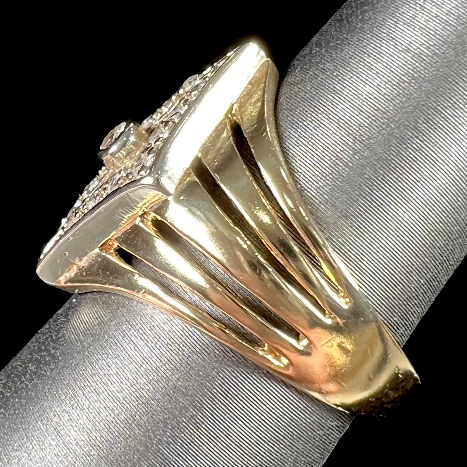 An estate ladies' gold diamond ring.  The shape of the ring resembles an art deco style diamond.