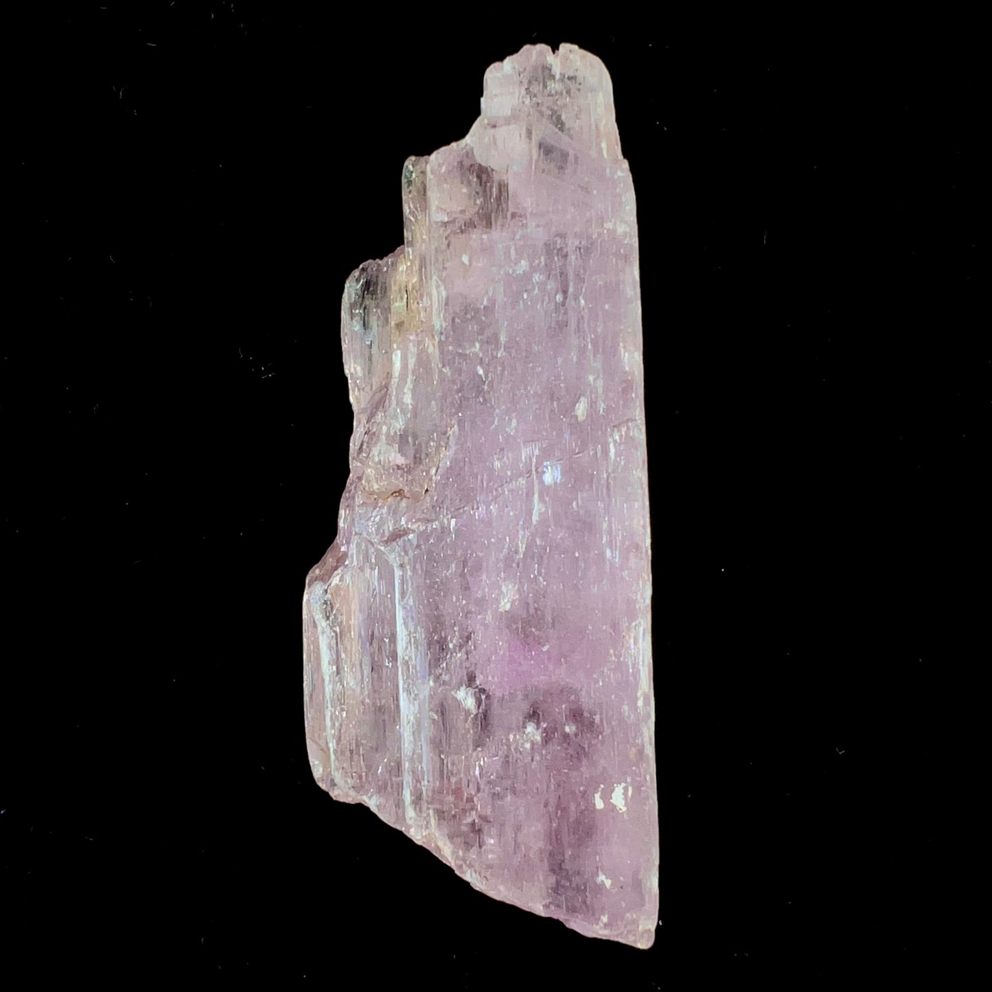 A five inch long pink kunzite crystal.  The crystal is purple when viewed down the ends.