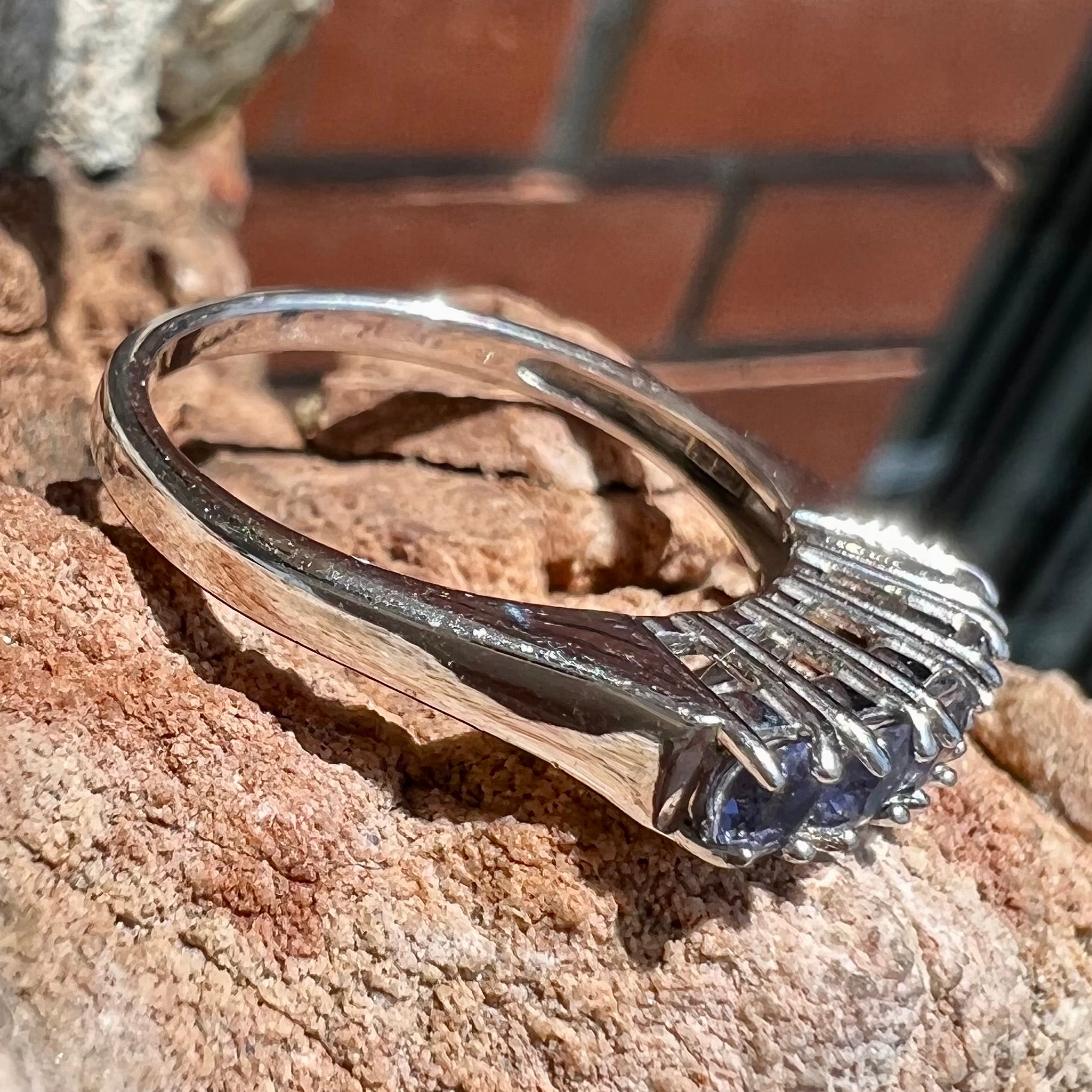 A sterling silver stackable ring set with five Standard Round Brilliant Cut tanzanite stones.