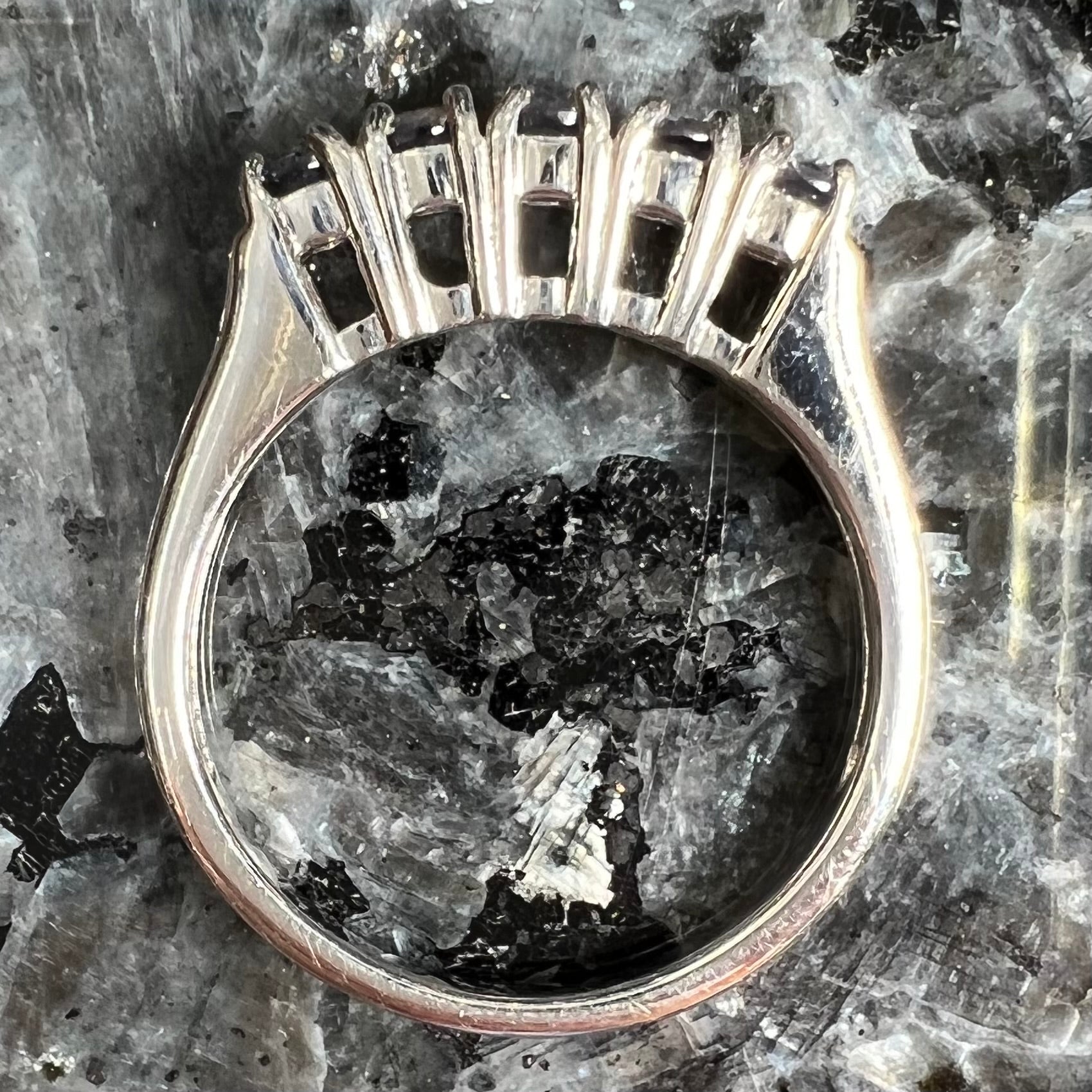 A sterling silver stackable ring set with five Standard Round Brilliant Cut tanzanite stones.