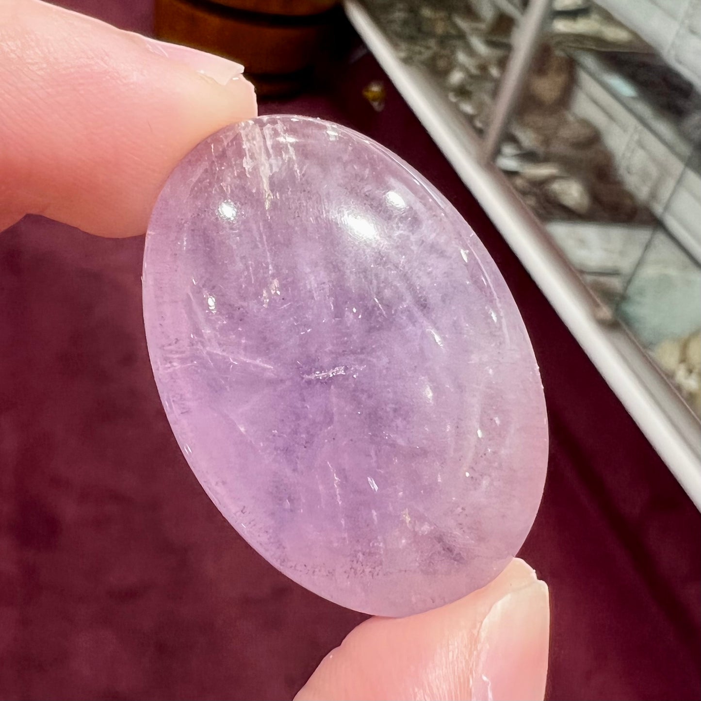 A cabochon cut red amethyst stone from Mexico.  The piece shows a faint star.