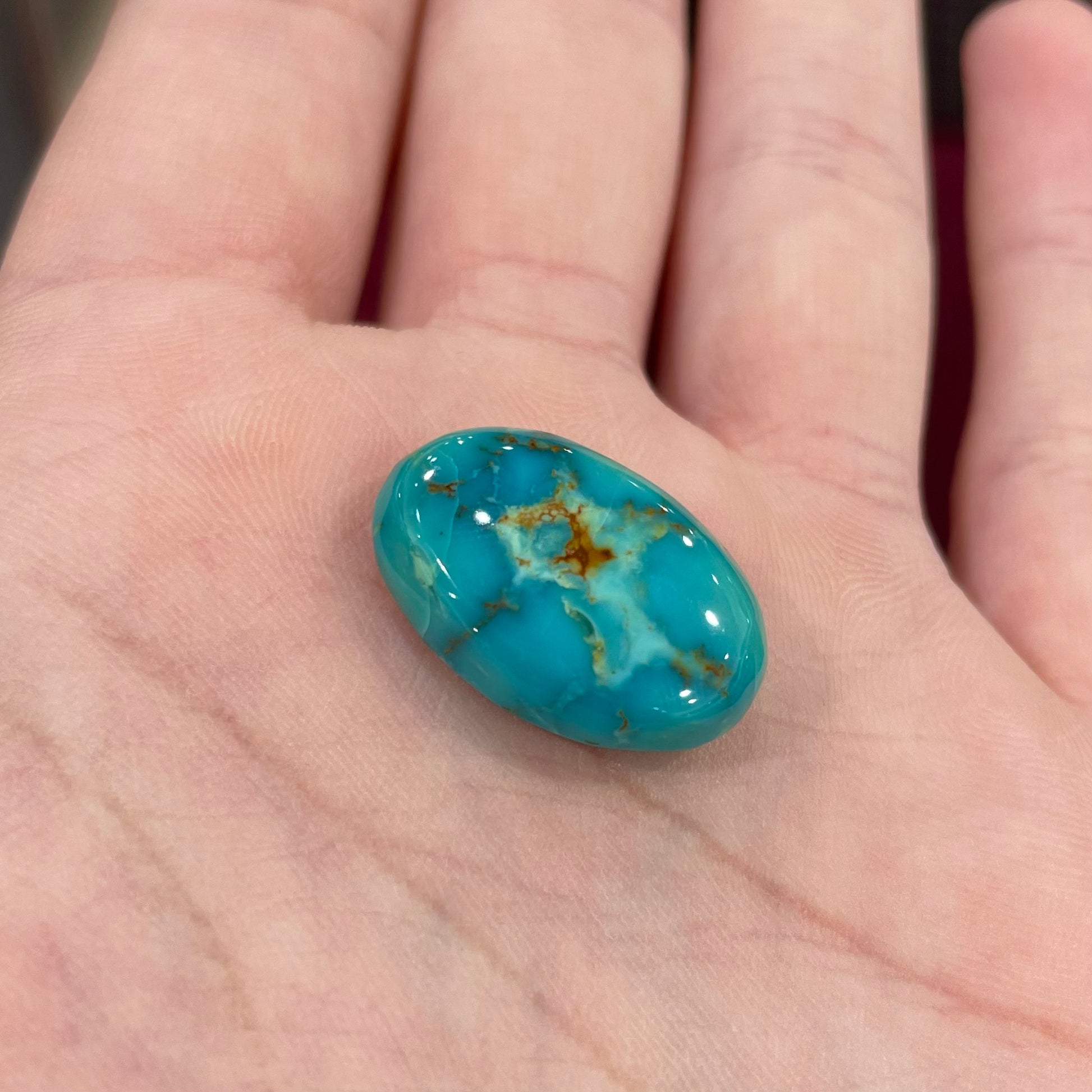 Loose Pilot Mountain turquoise with a pattern of brown matrix spots that resembles a star.  星绿松石