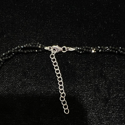 A beaded necklace made of black spinel.