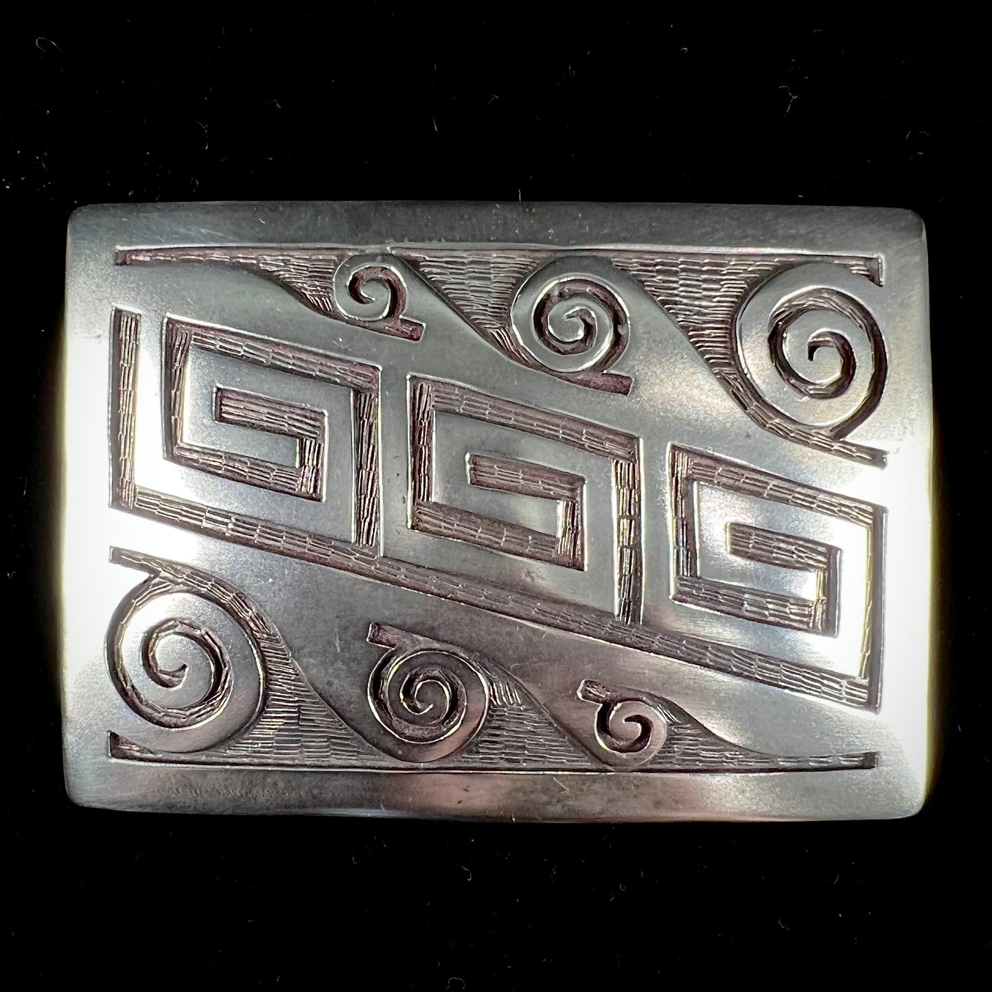 A sterling silver belt buckle handmade by Navajo artist Stanley Bain.