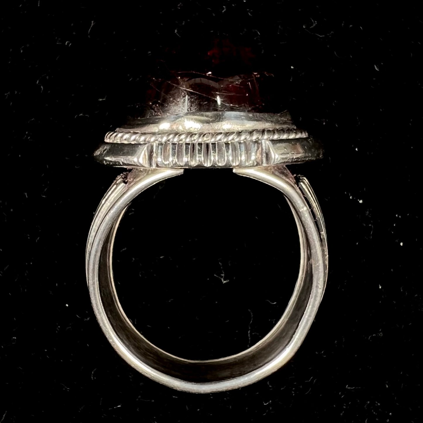 A men's sterling silver garnet ring handmade by Navajo artist Will Denetdale.