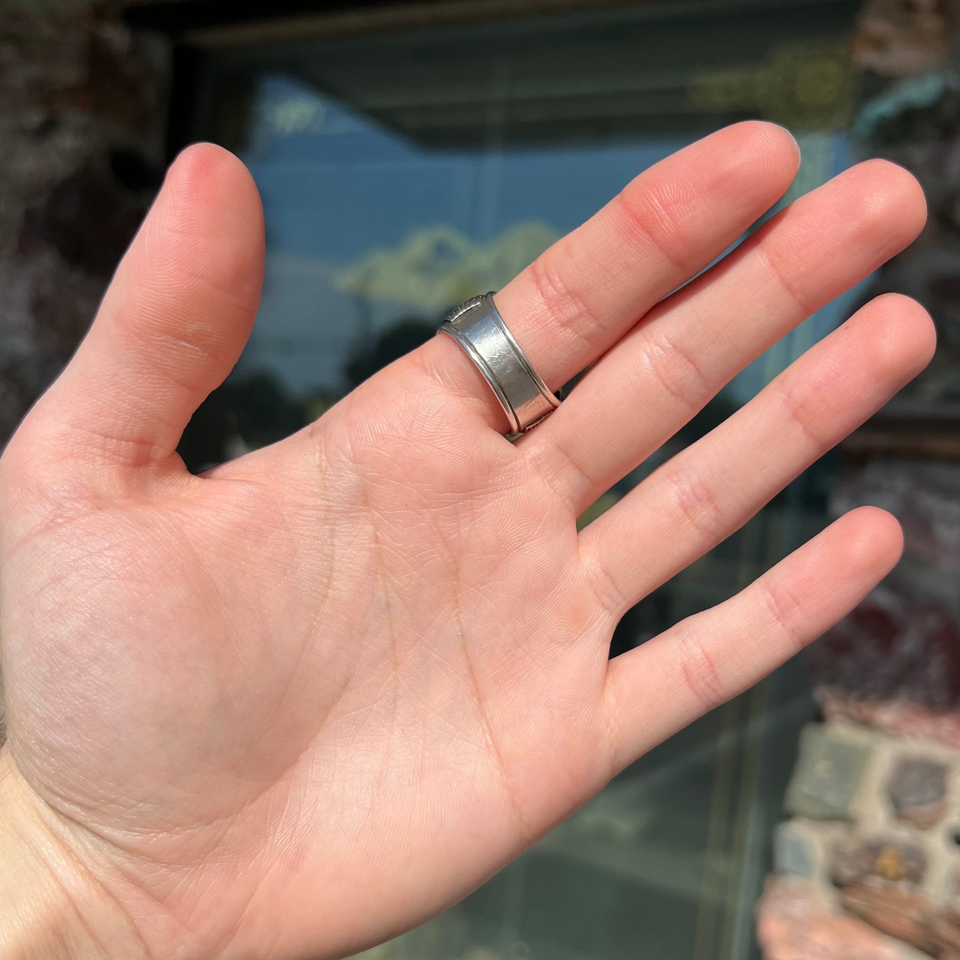 A men's sterling silver garnet ring handmade by Navajo artist Will Denetdale.