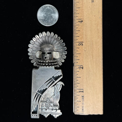 A Morning Singer kachina doll pendant made from sterling silver by Navajo artist Bennie Ration.