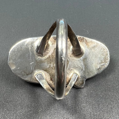 A Southwest style silver ring set with a faint pink mother of pearl stone.