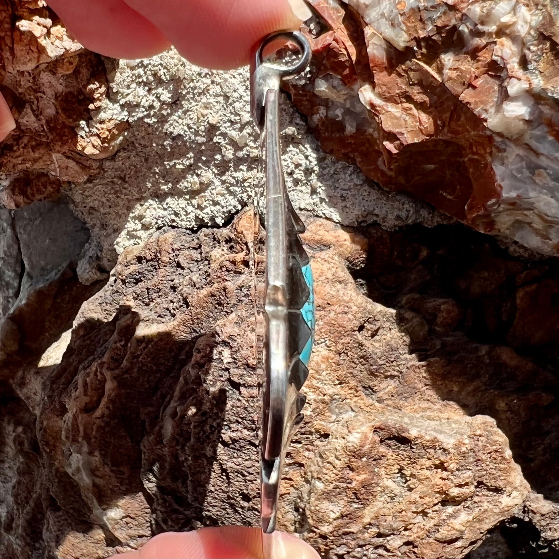 A handmade Mayan Indian pendant set with an oval cut turquoise stone from the Number 8 Mine.