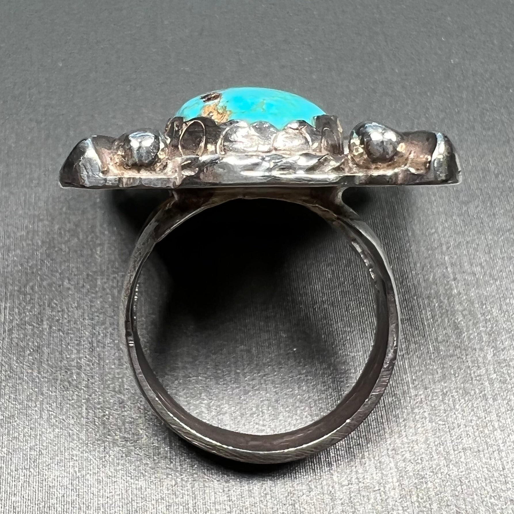 A sterling silver ring set with Tyrone turquoise from Burro Mountains, New Mexico.