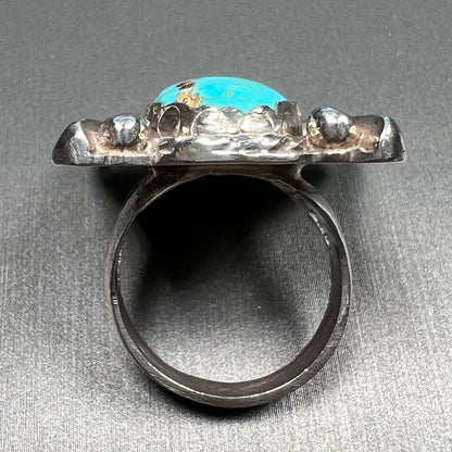 A sterling silver ring set with Tyrone turquoise from Burro Mountains, New Mexico.