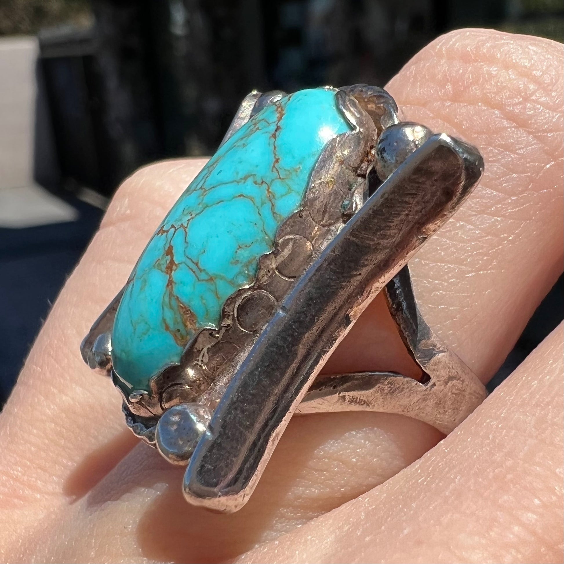 A sterling silver ring set with Tyrone turquoise from Burro Mountains, New Mexico.