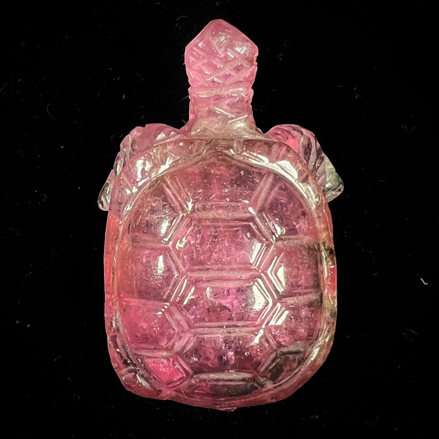 A crystal turtle carved from a pink tourmaline stone.