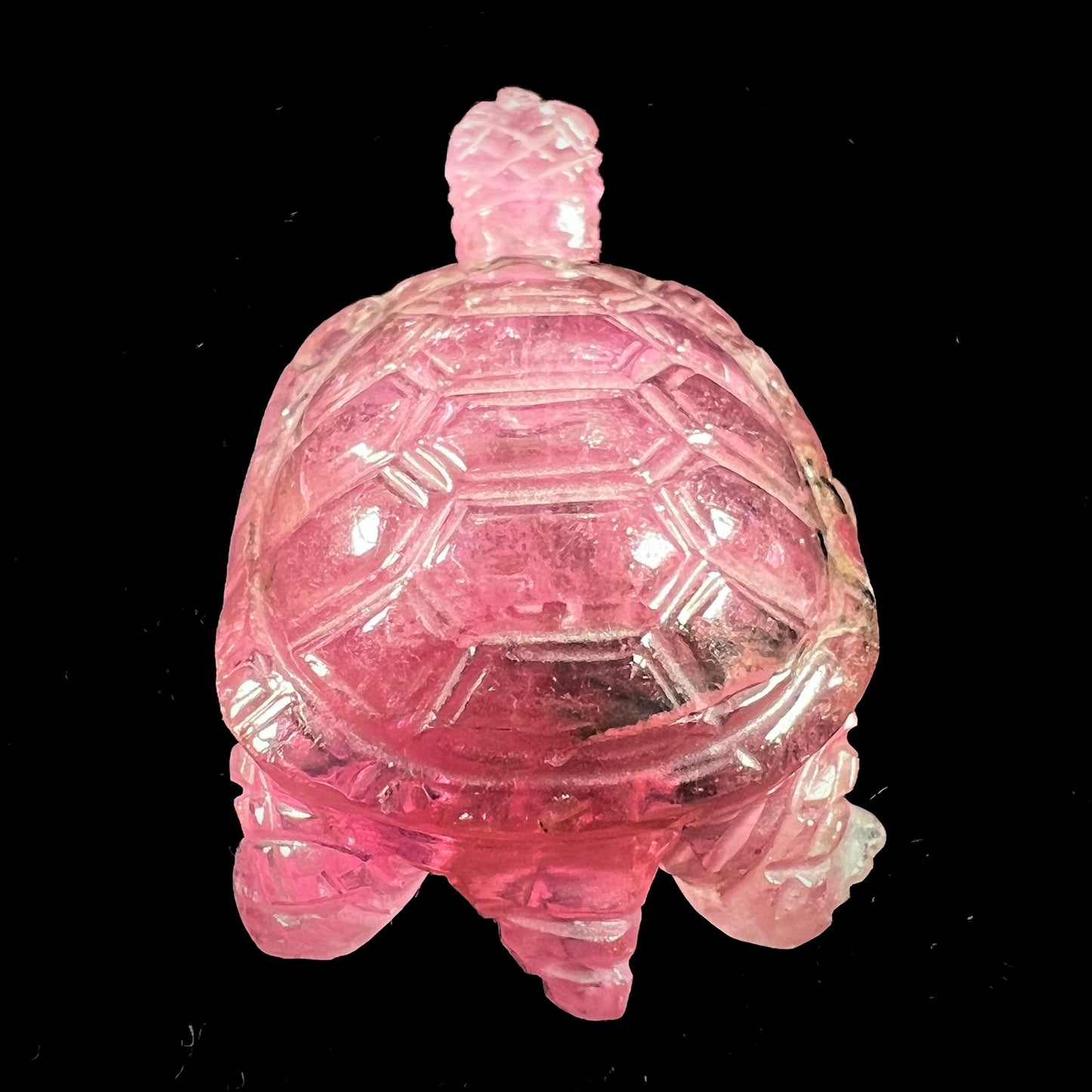 A crystal turtle carved from a pink tourmaline stone.