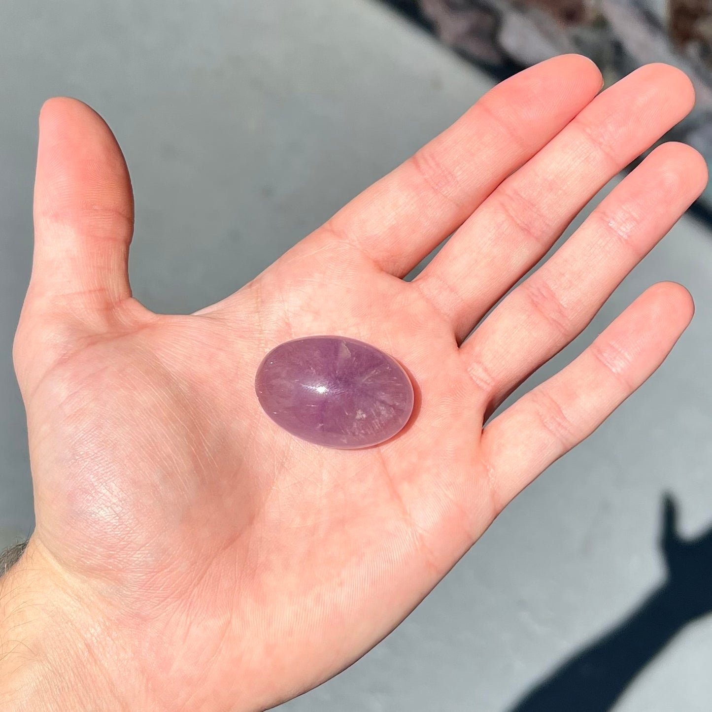 A cabochon cut red amethyst stone from Mexico.  The piece shows a faint star.