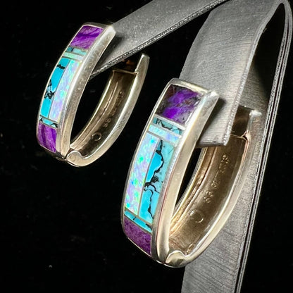 A pair sterling silver inlay earrings set with turquoise, sugilite, and lab created opal stones.