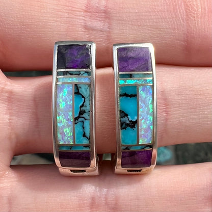 A pair sterling silver inlay earrings set with turquoise, sugilite, and lab created opal stones.