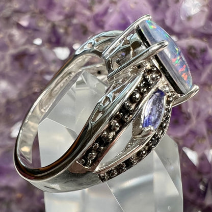 A sterling silver black opal triplet ring set with black spinel and marquise cut tanzanite accent stones.