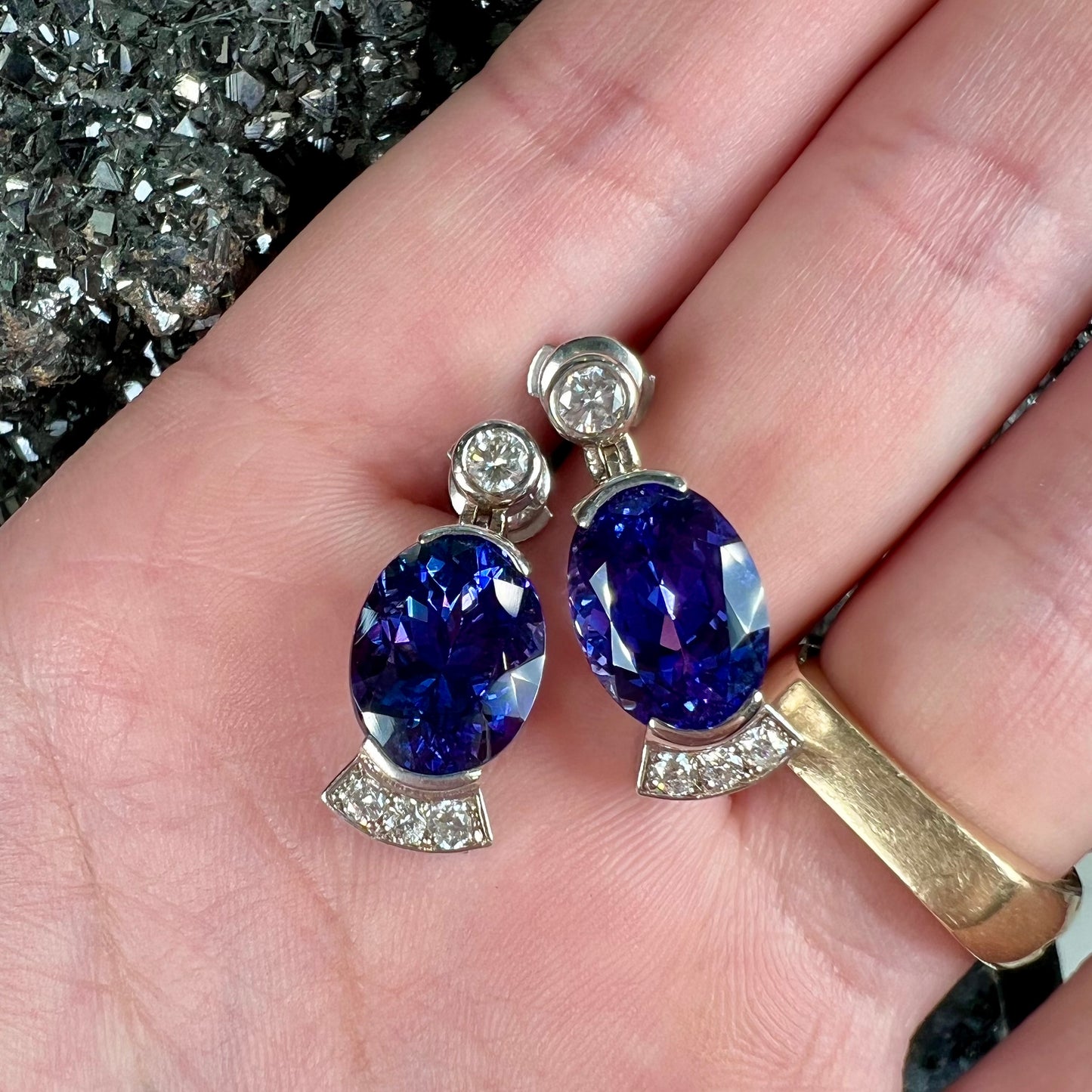 A pair of white gold, AAA grade tanzanite & diamond dangle earrings.