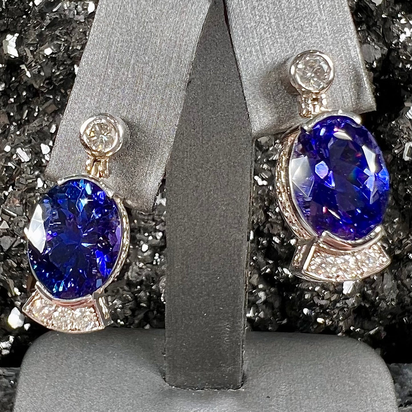 A pair of white gold, AAA grade tanzanite & diamond dangle earrings.