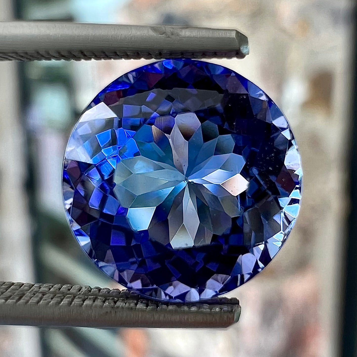 A loose, AA grade Standard Round Brilliant Cut tanzanite stone.