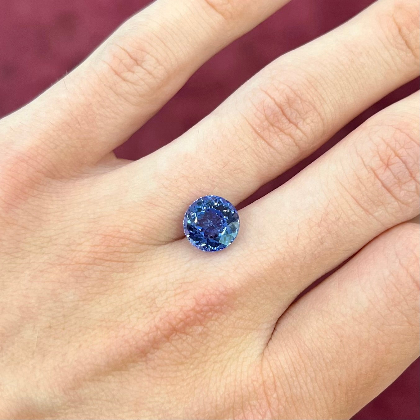 A loose, AA grade Standard Round Brilliant Cut tanzanite stone.