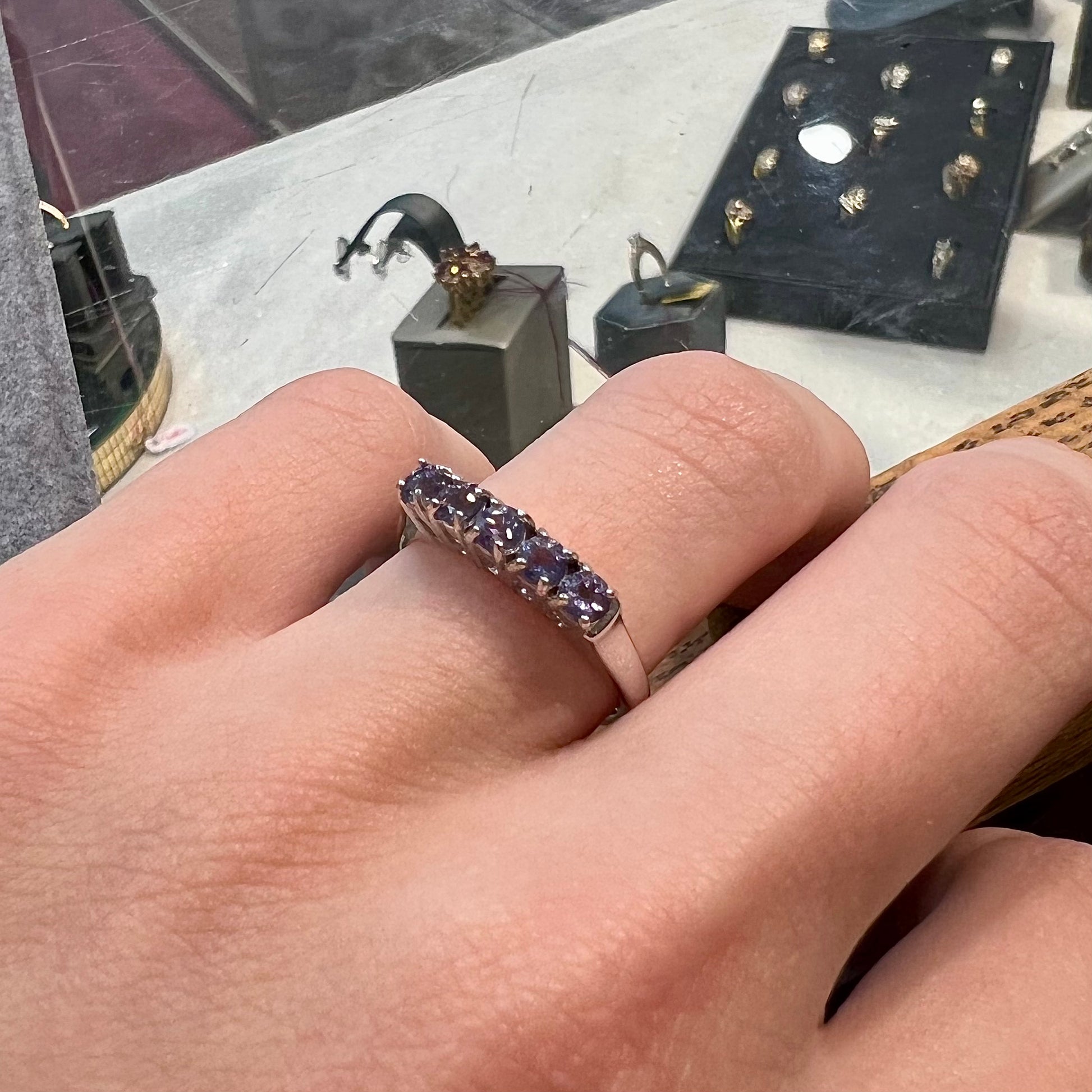A sterling silver stackable ring set with five Standard Round Brilliant Cut tanzanite stones.