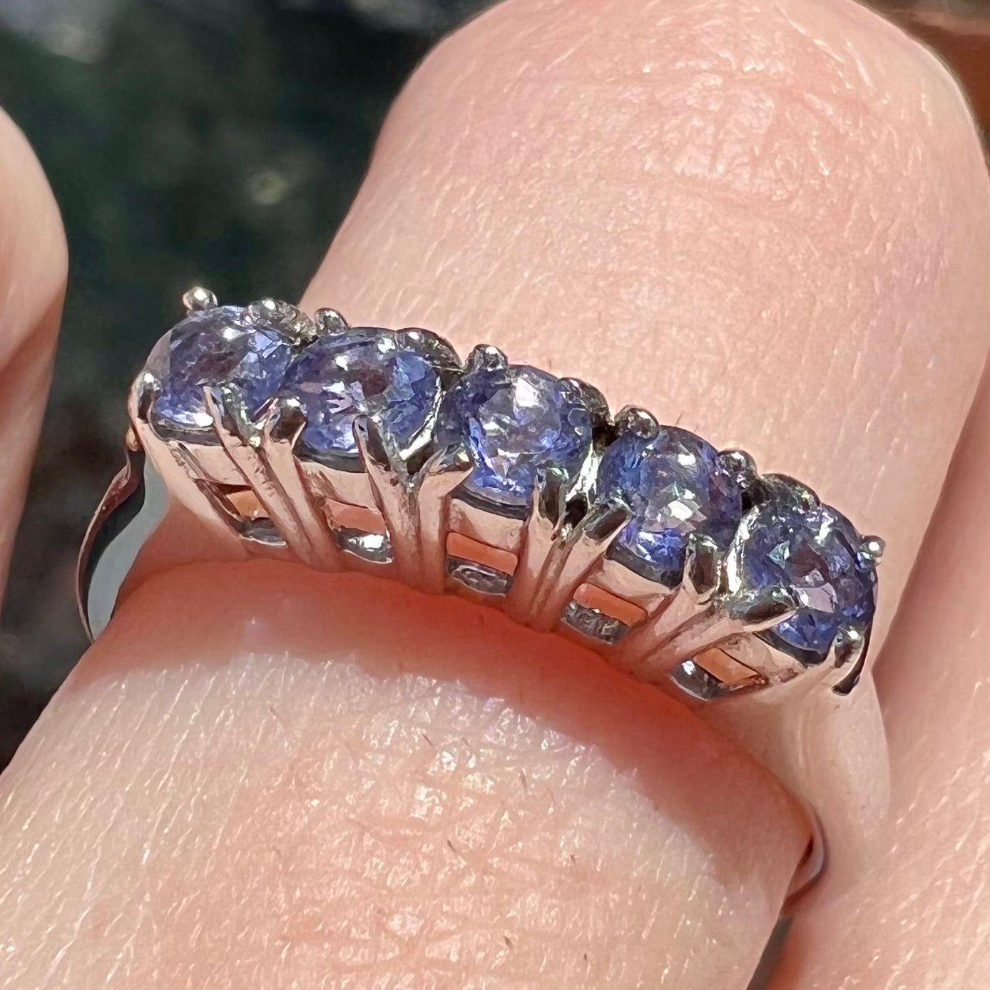 A sterling silver stackable ring set with five Standard Round Brilliant Cut tanzanite stones.