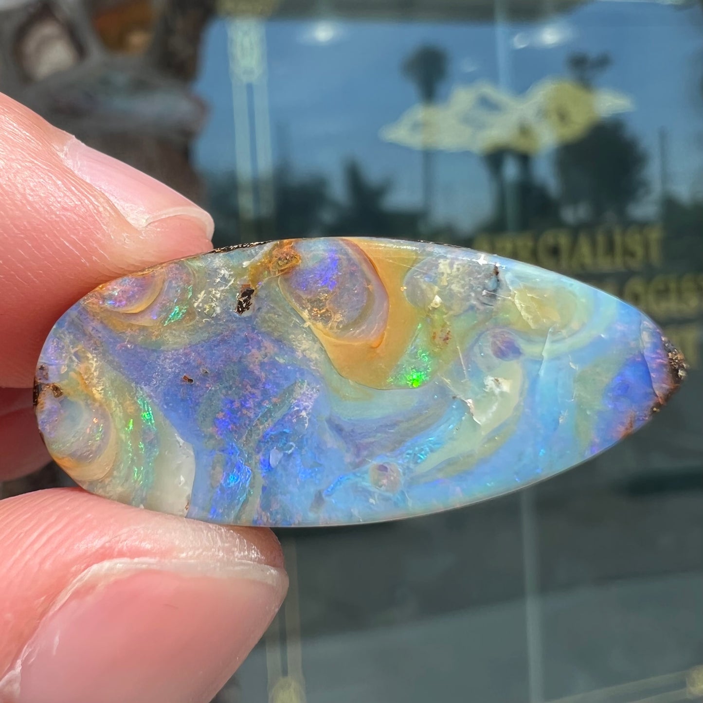 A loose, natural, pear shaped boulder opal stone from Quilpie, Australia.