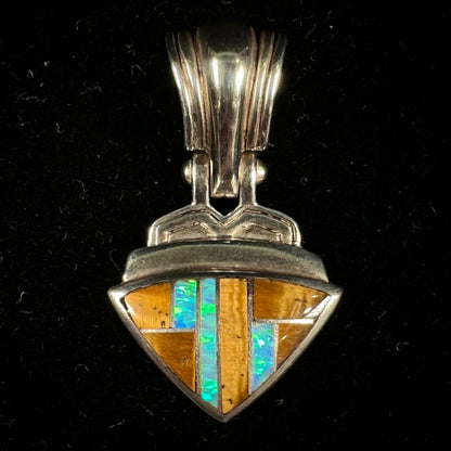 A Navajo-made pendant inlaid with tiger's eye and synthetic opal stones.