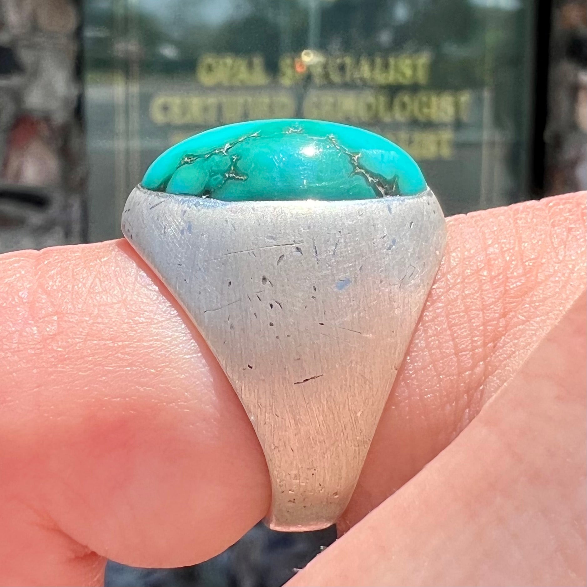 A men's textured silver turquoise solitaire ring.  The turquoise is from Royston Mining District, Nevada.