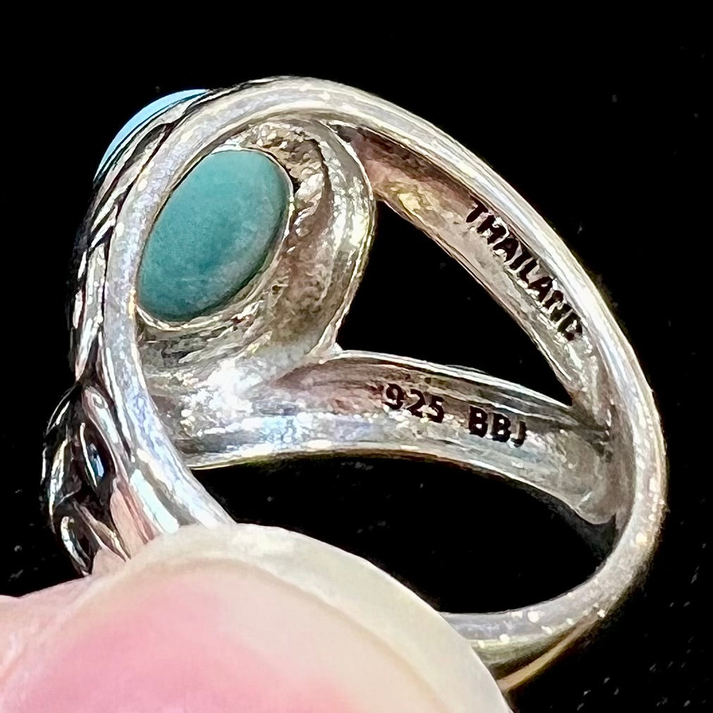 Sterling silver ring with black antiqued highlights set with blue larimar stone.  The piece is stamped "THAILAND" and "925 BBJ."
