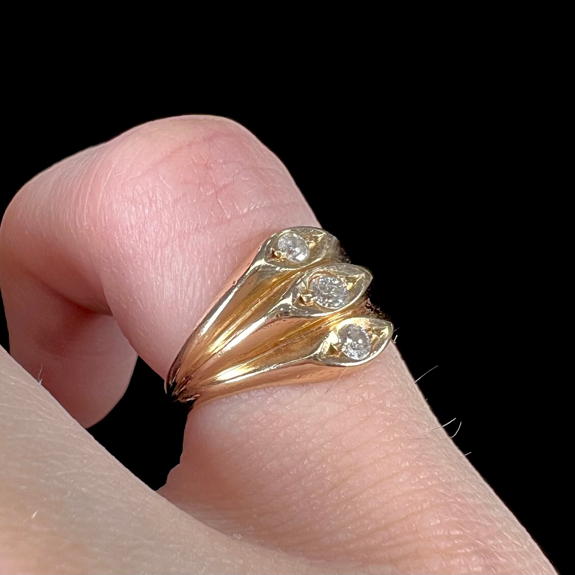 A vintage 1940's style ladies' yellow gold three stone diamond ring.