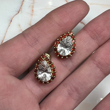 Pear shape white topaz and garnet halo stud earrings in yellow gold.
