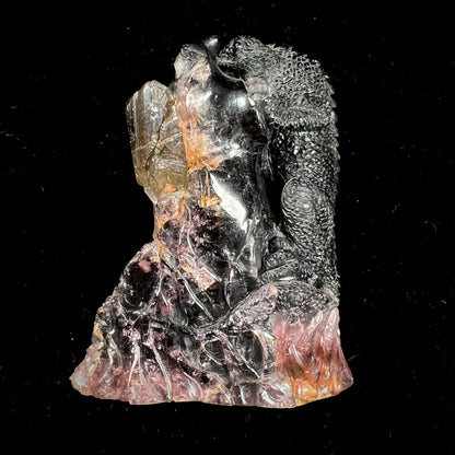 A stone lizard carved by artist, Ronald Stevens, from a liddicoatite tourmaline crystal.