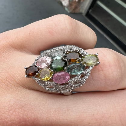 A silver gemstone cluster ring set with a rainbow of multicolored tourmaline stones.