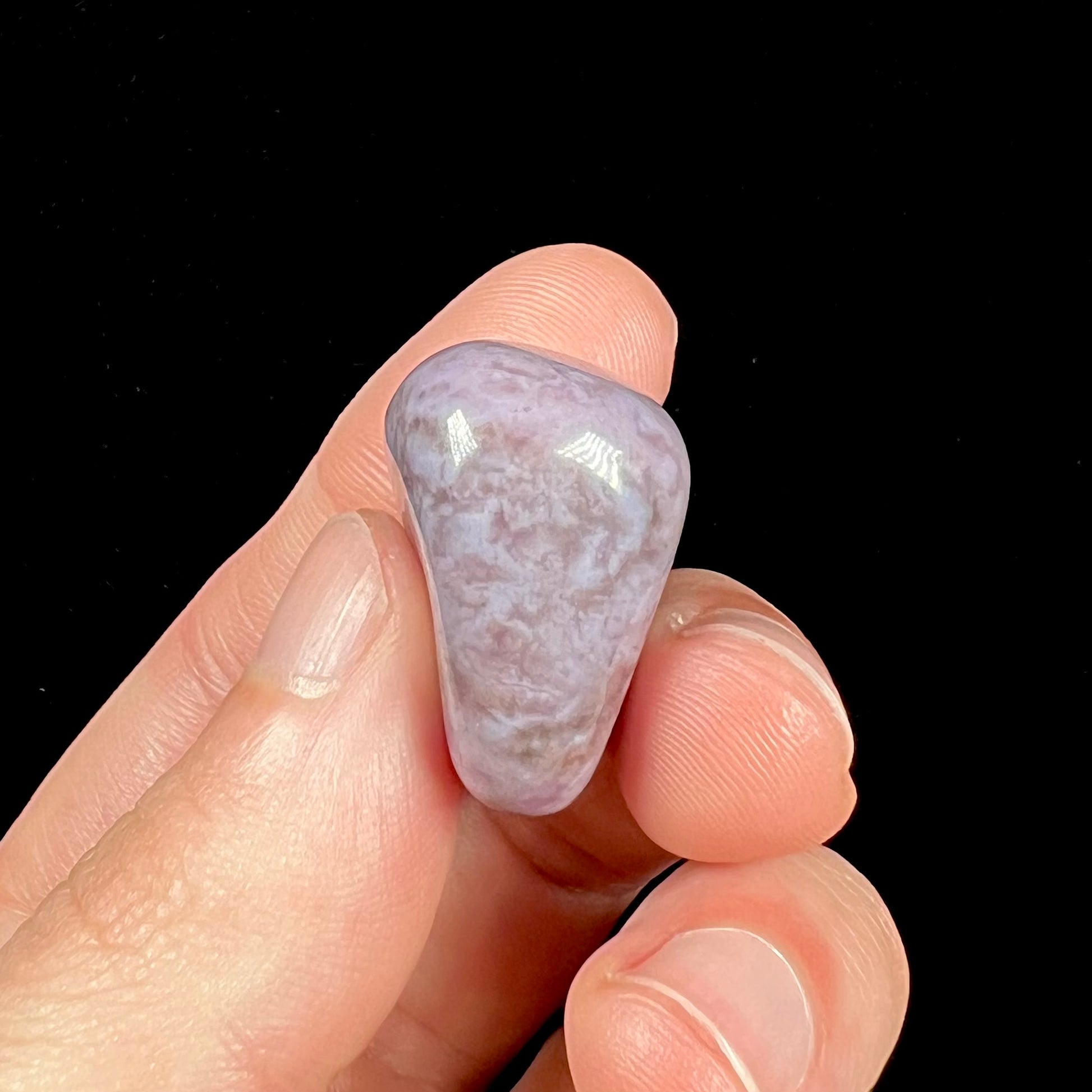 A tumbled Turkish purple jade stone.  The material is a "white" lilac purple color.