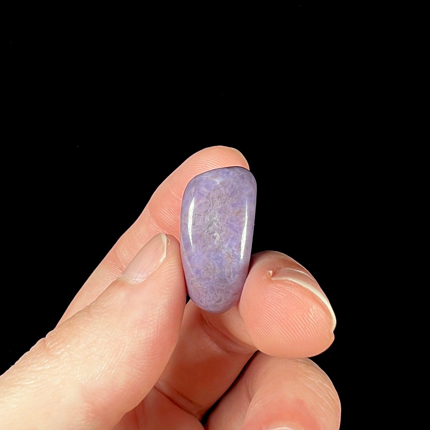 A tumble polished piece of purple turkiyenite jade stone.  Material from Bursa, Turkey.